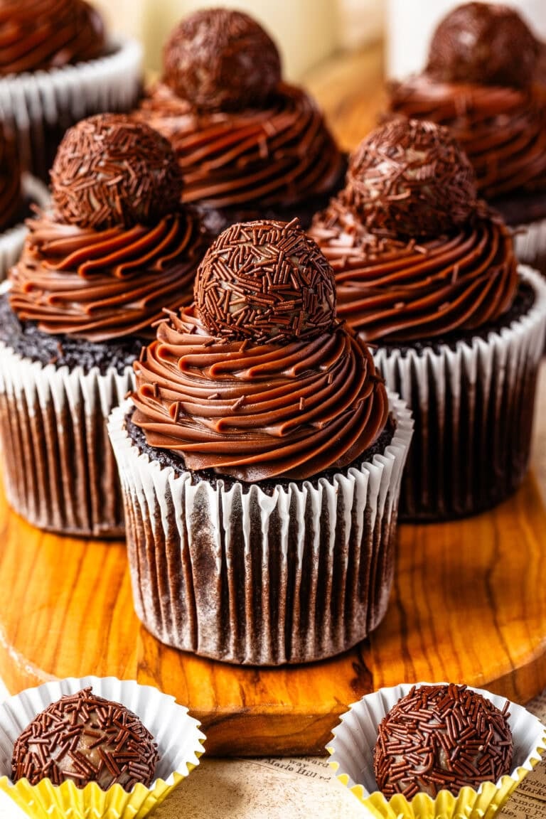 Brigadeiro Cupcakes topped with silky chocolate Briganache frosting, chocolate sprinkles, and a classic brigadeiro.